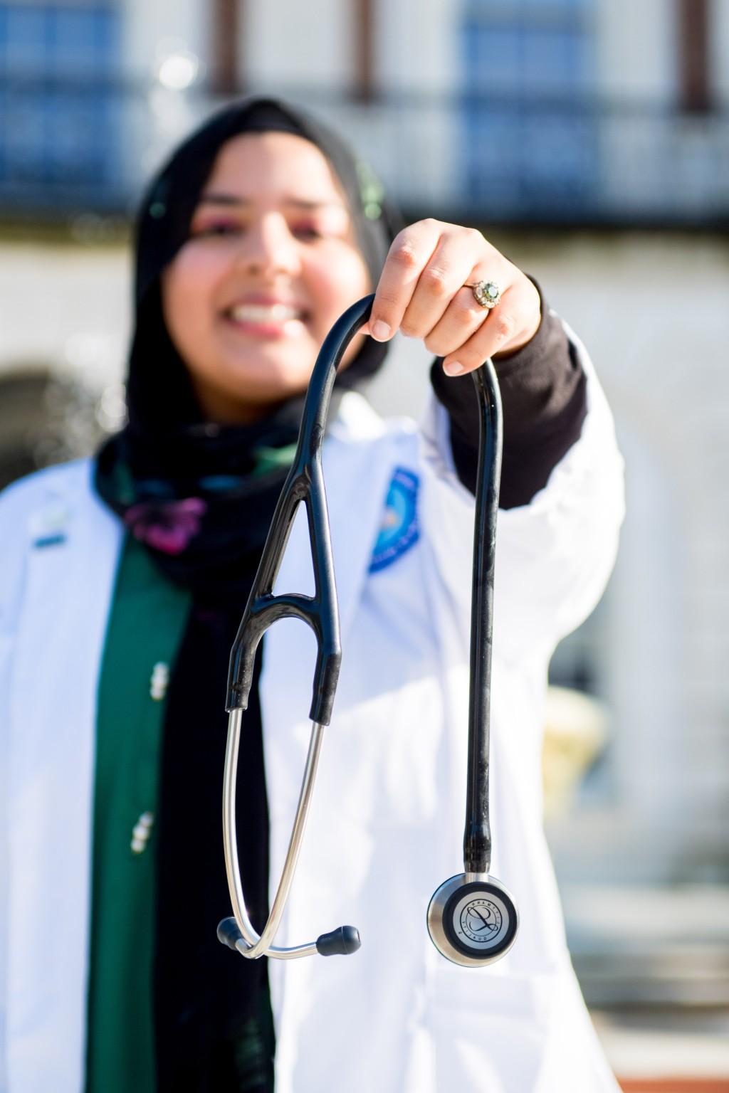 Fajar holds up her stethoscope