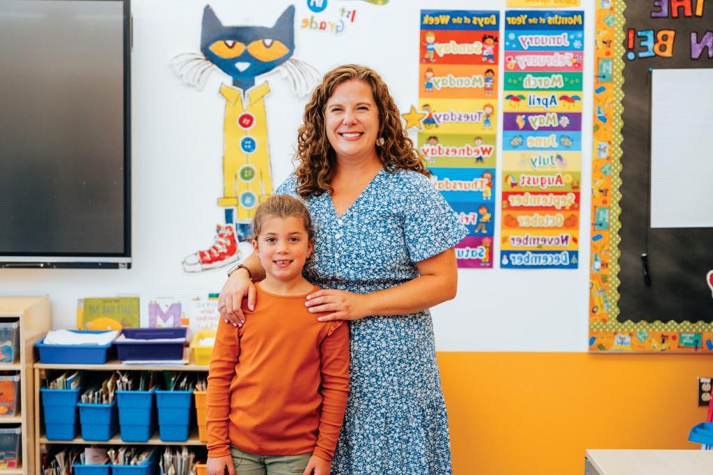 Emily Rosser stands with her daughter in her elementary school classroom